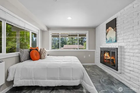 a bedroom with a bed and a fireplace