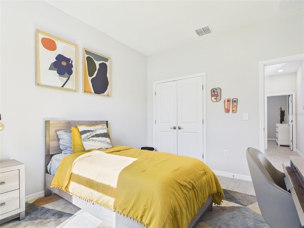 8499 North Inca Way Dunnellon, FL 34434 - Photo 23 of 35 a bedroom with a bed and painting on the wall