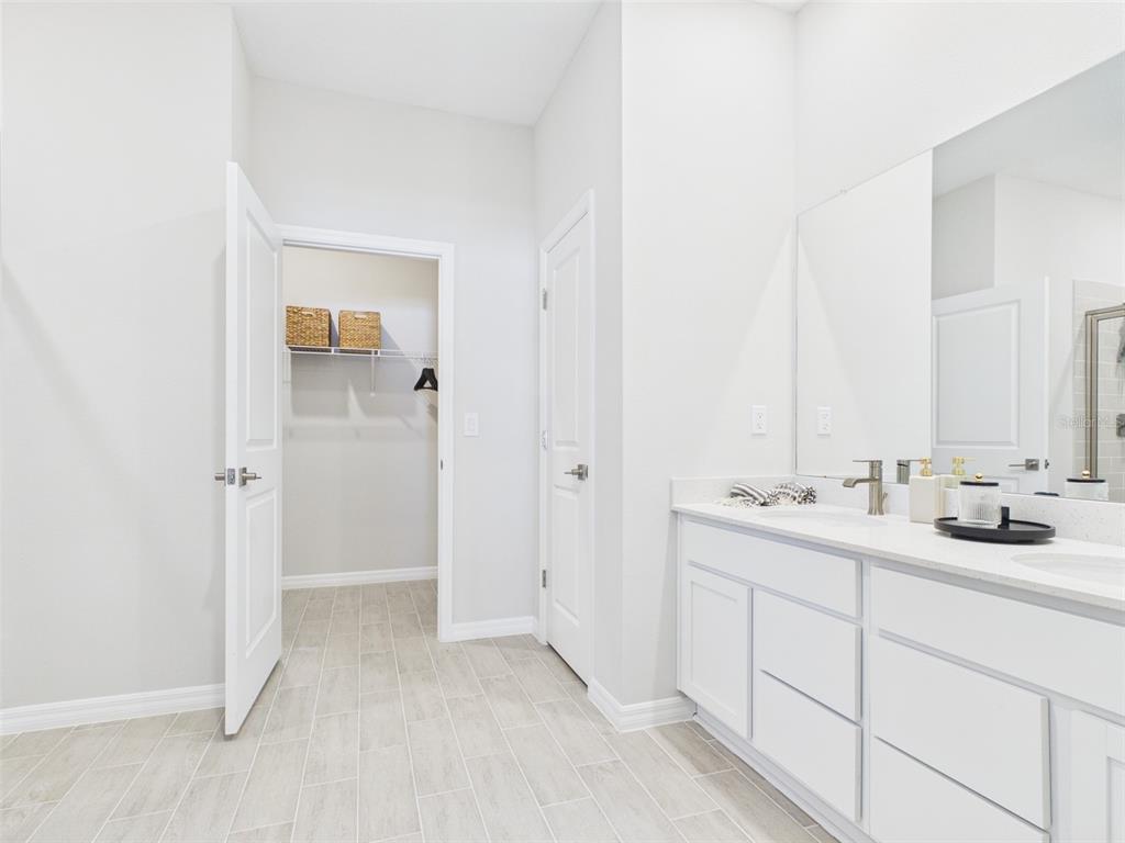 8499 North Inca Way Dunnellon, FL 34434 - Photo 27 of 35 a bathroom with a double vanity sink and mirror