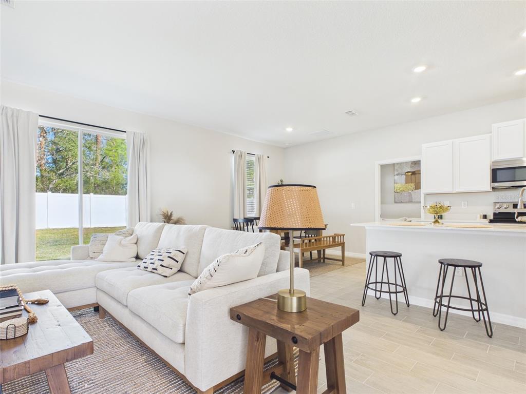 8499 North Inca Way Dunnellon, FL 34434 - Photo 4 of 35 a living room with furniture a rug and a large window