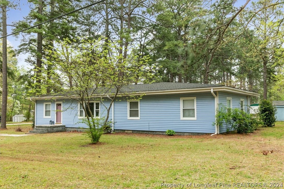 a front view of house with yard and trees