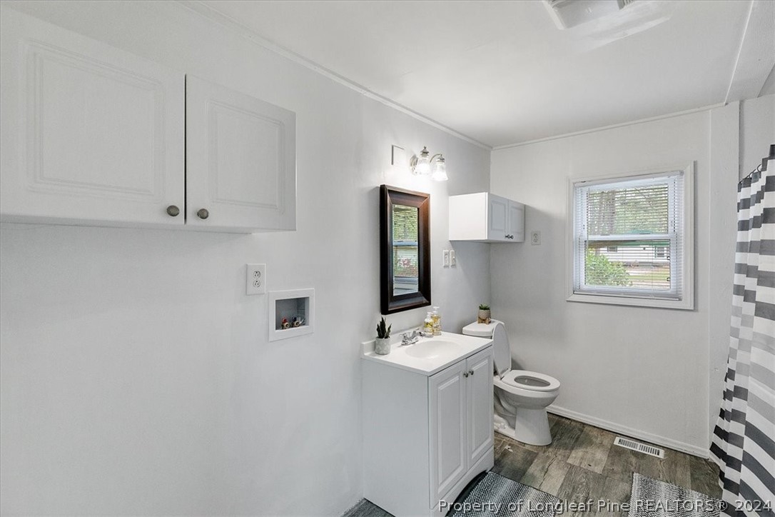 650 McKay Drive Spring Lake, NC 28390 - Photo 15 of 37 a bathroom with a toilet sink and mirror