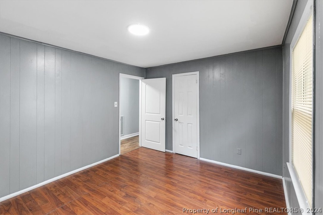 650 McKay Drive Spring Lake, NC 28390 - Photo 19 of 37 a view of an empty room with wooden floor and a window