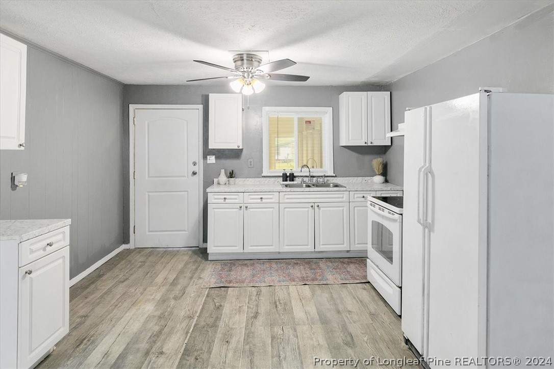 650 McKay Drive Spring Lake, NC 28390 - Photo 25 of 37 a large white kitchen with cabinets a sink and dishwasher
