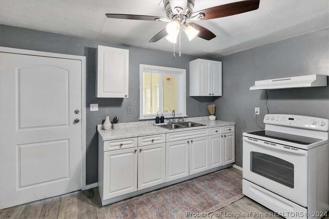650 McKay Drive Spring Lake, NC 28390 - Photo 27 of 37 a kitchen with a sink stove and microwave