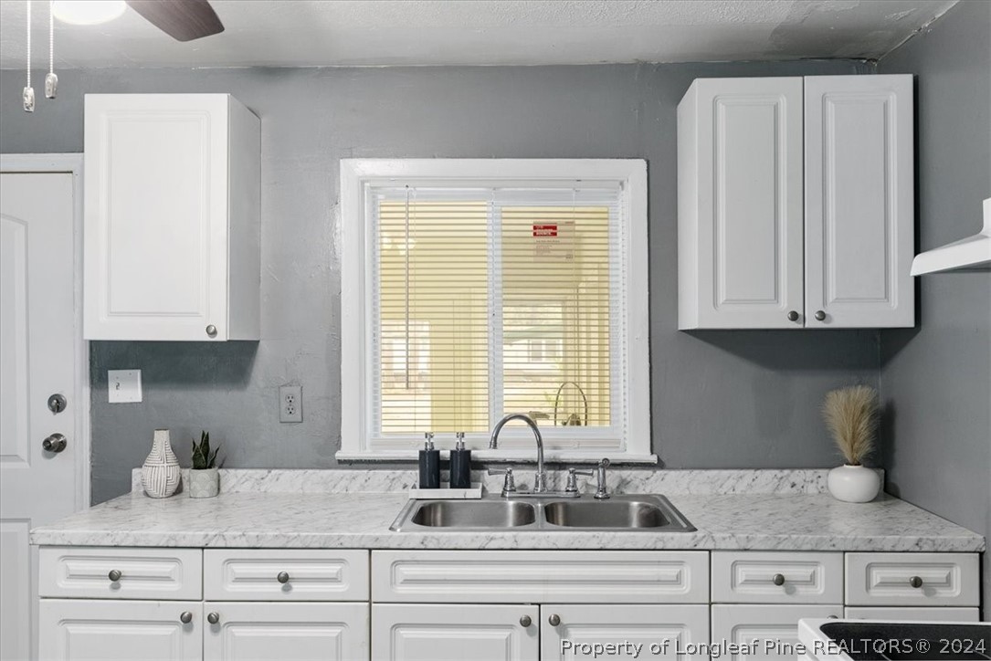 650 McKay Drive Spring Lake, NC 28390 - Photo 28 of 37 a kitchen with granite countertop white cabinets and a sink