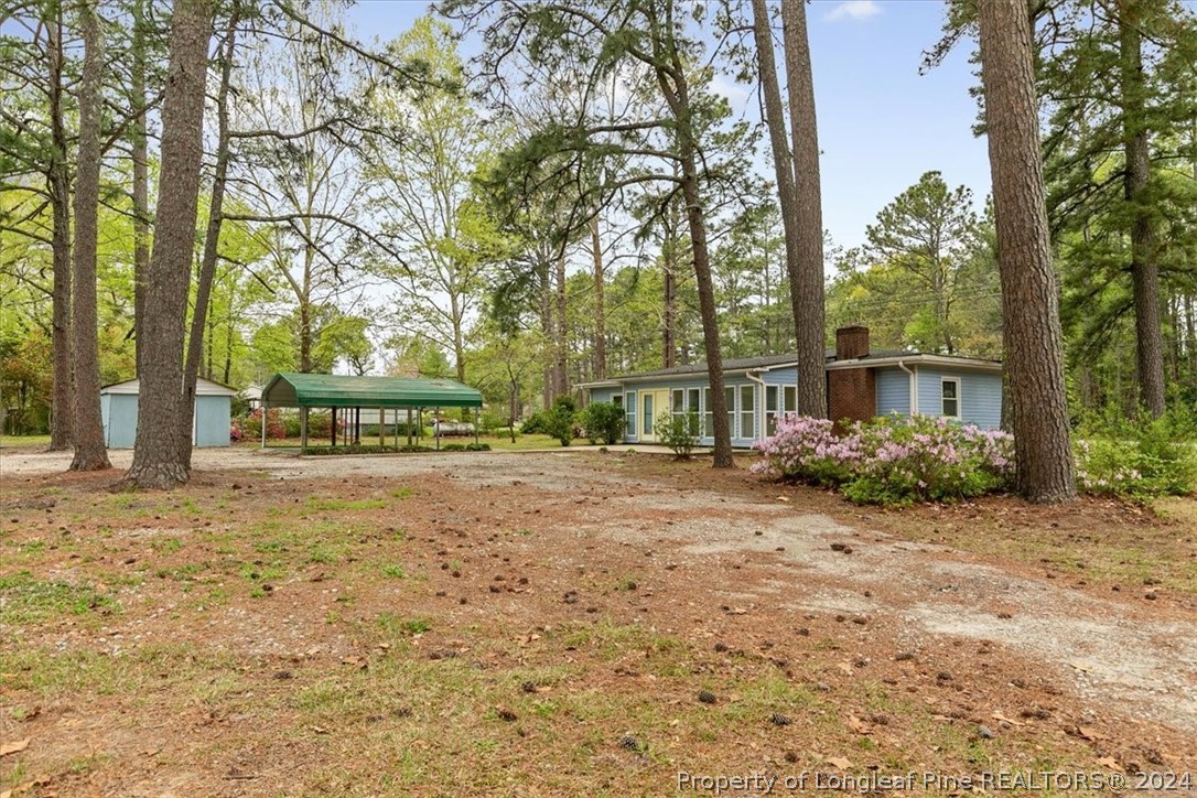 650 McKay Drive Spring Lake, NC 28390 - Photo 35 of 37 a view of a house with yard and trees
