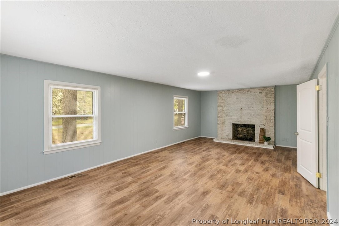 650 McKay Drive Spring Lake, NC 28390 - Photo 6 of 37 an empty room with windows and fireplace