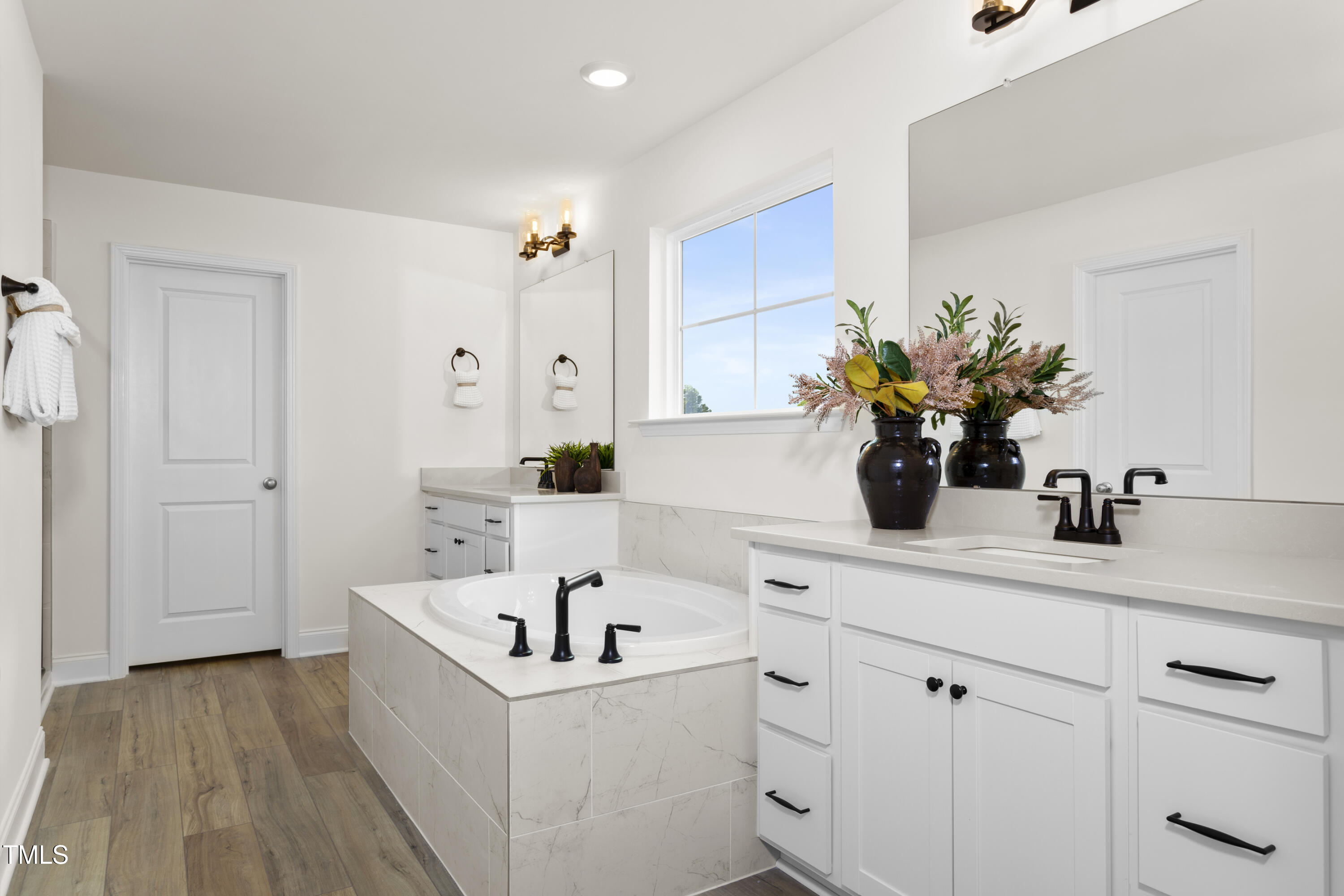 315 Adams Pointe Court Angier, NC 27501 - Photo 14 of 25 a white kitchen with a sink a mirror and a potted plant