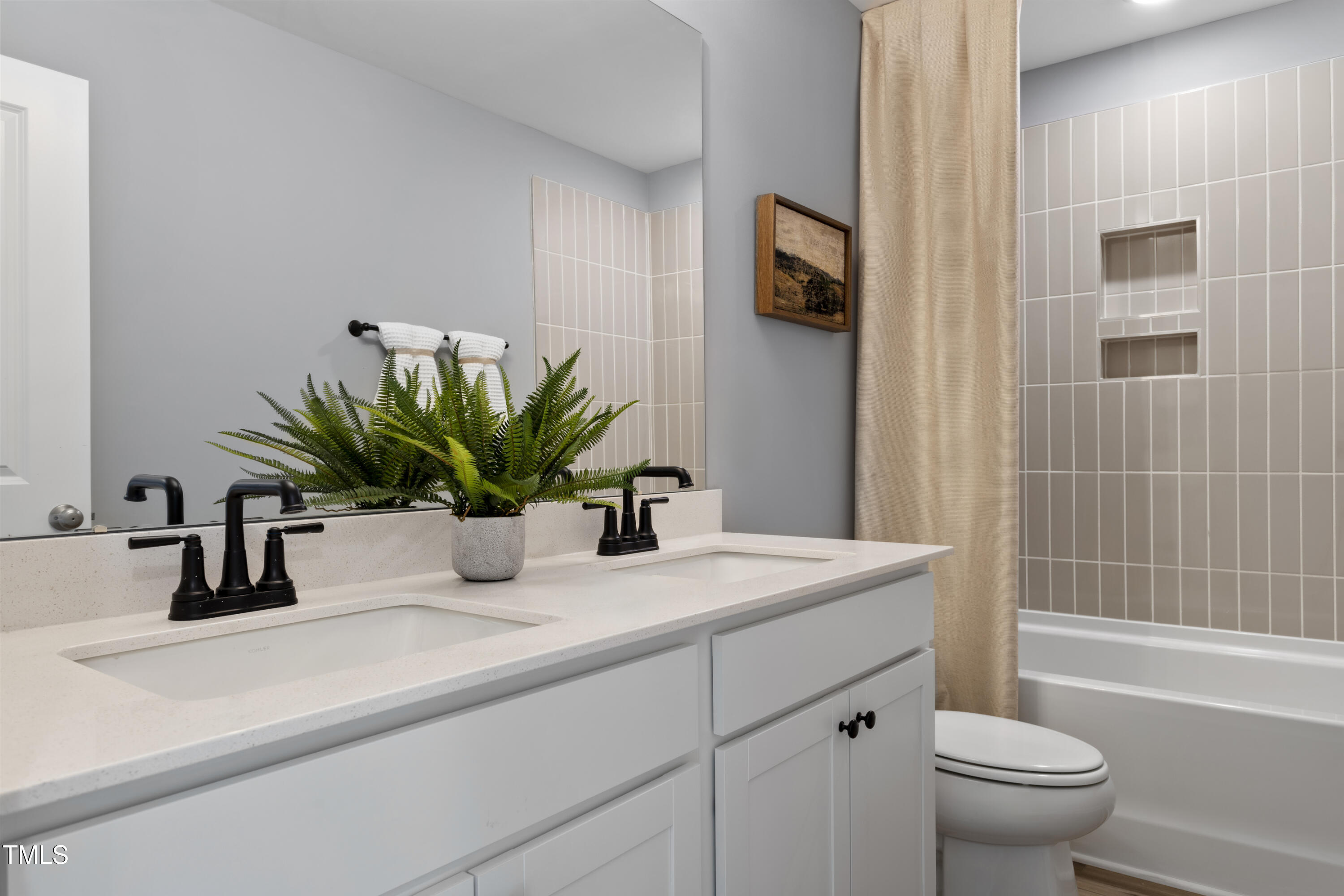 315 Adams Pointe Court Angier, NC 27501 - Photo 16 of 25 a bathroom with a sink a toilet a mirror and shower