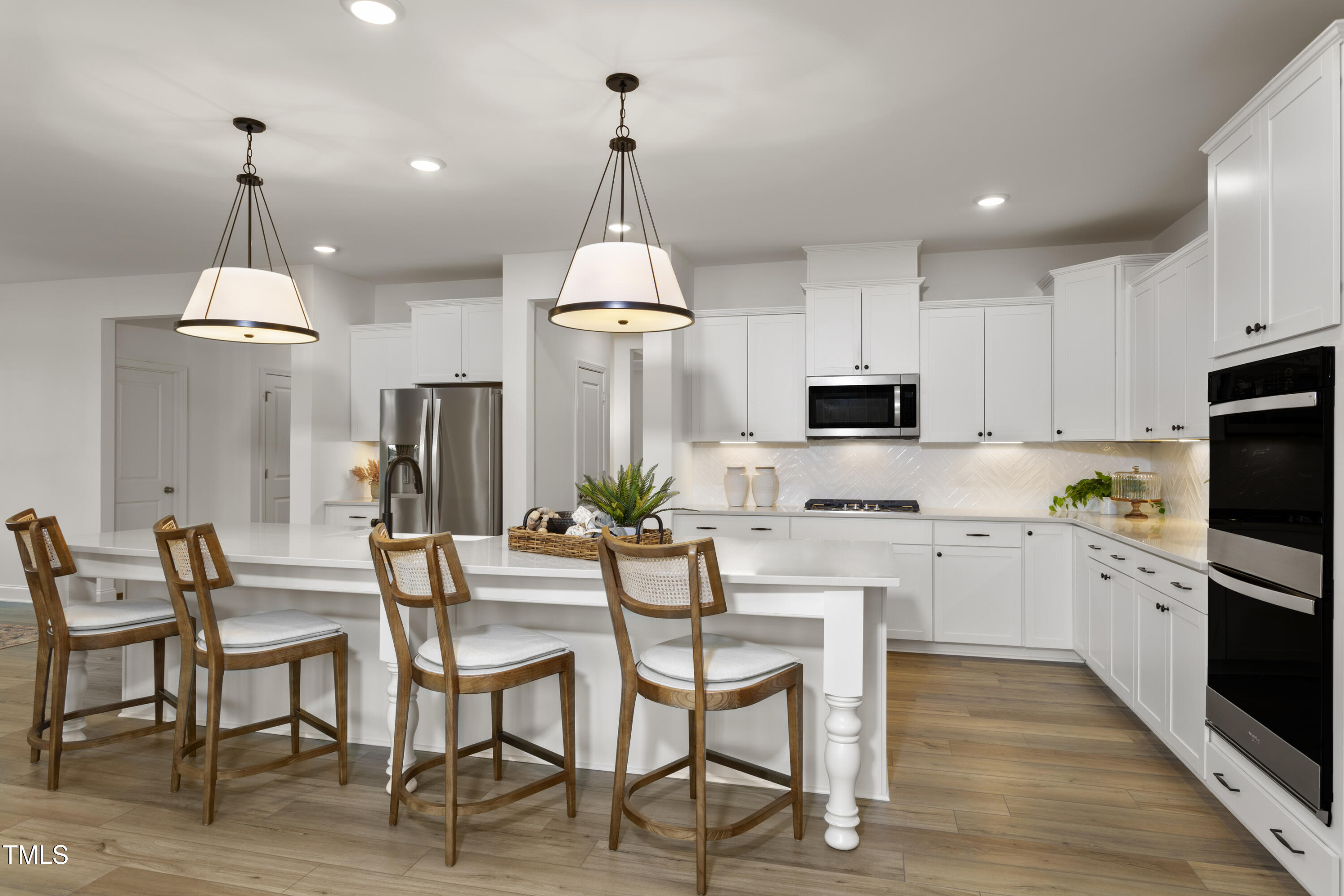 315 Adams Pointe Court Angier, NC 27501 - Photo 8 of 25 a open kitchen with stainless steel appliances granite countertop a dining table chairs stove a microwave and a refrigerator