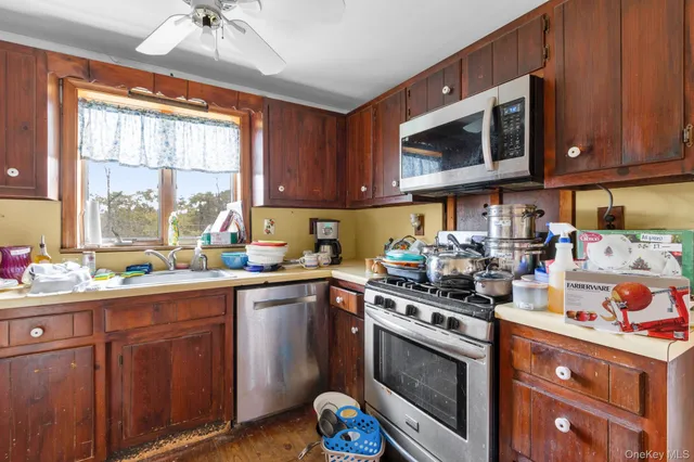 a view of a dining room with furniture large windows and wooden floor