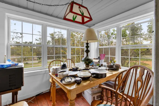a bedroom with furniture and a wooden floor