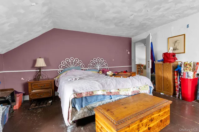 a bed room with a bed a desk and a window