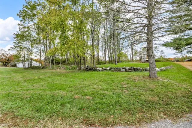a living room with furniture kitchen view and a chandelier
