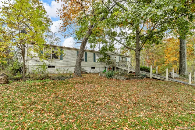 a living room with furniture fireplace and a window
