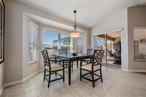 a dining room with furniture and window