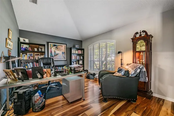 a living room with lots of furniture and a book shelf