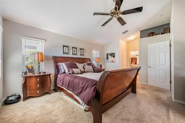 a bed room with a bed and a ceiling fan