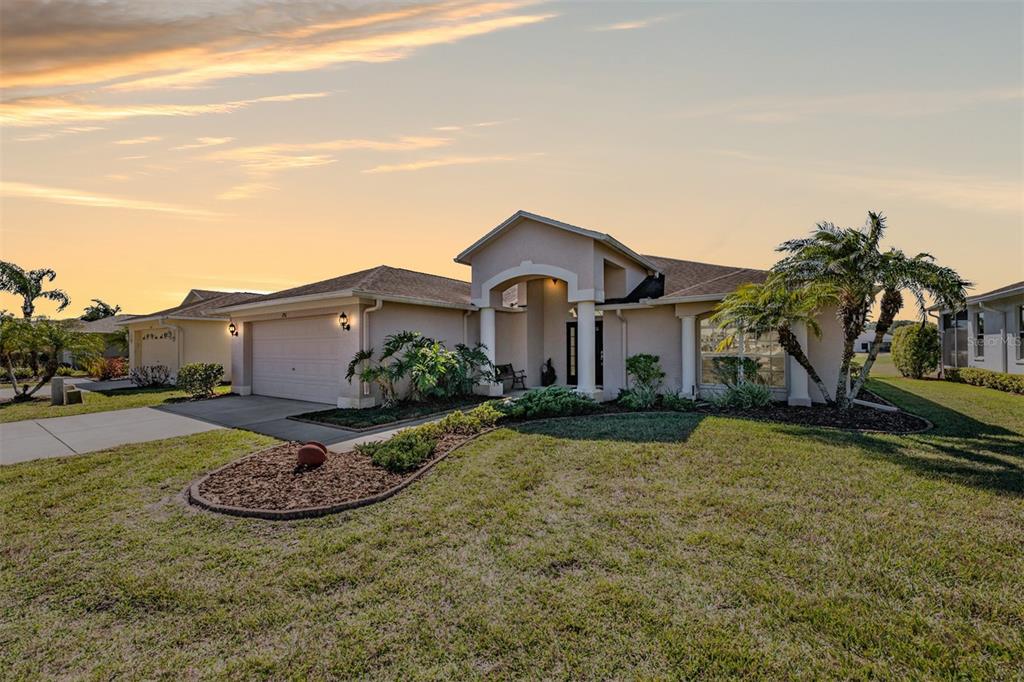 1751 Lakestone Drive Trinity, FL 34655 - Photo 2 of 51 a front view of a house with garden