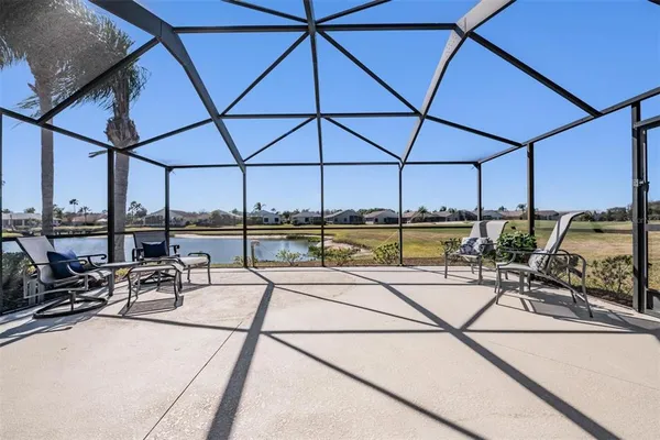 a view of a patio with a table and chairs under an umbrella