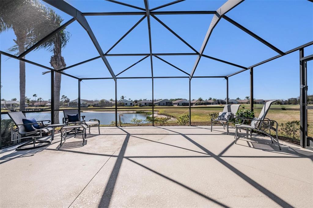 1751 Lakestone Drive Trinity, FL 34655 - Photo 22 of 51 a view of a patio with a table and chairs under an umbrella