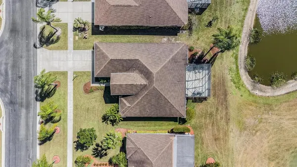 an aerial view of a house with a yard basket ball court