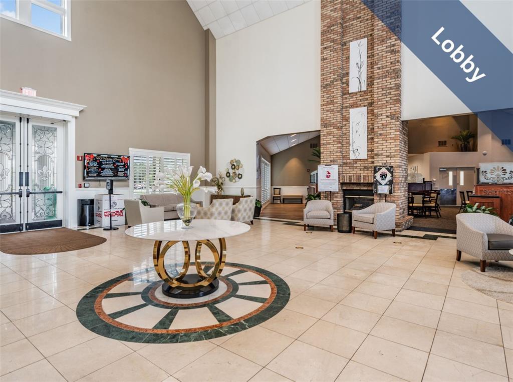 1751 Lakestone Drive Trinity, FL 34655 - Photo 41 of 51 a living room with furniture and a dining table with kitchen view
