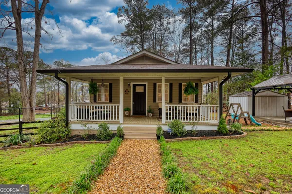 a front view of a house with garden