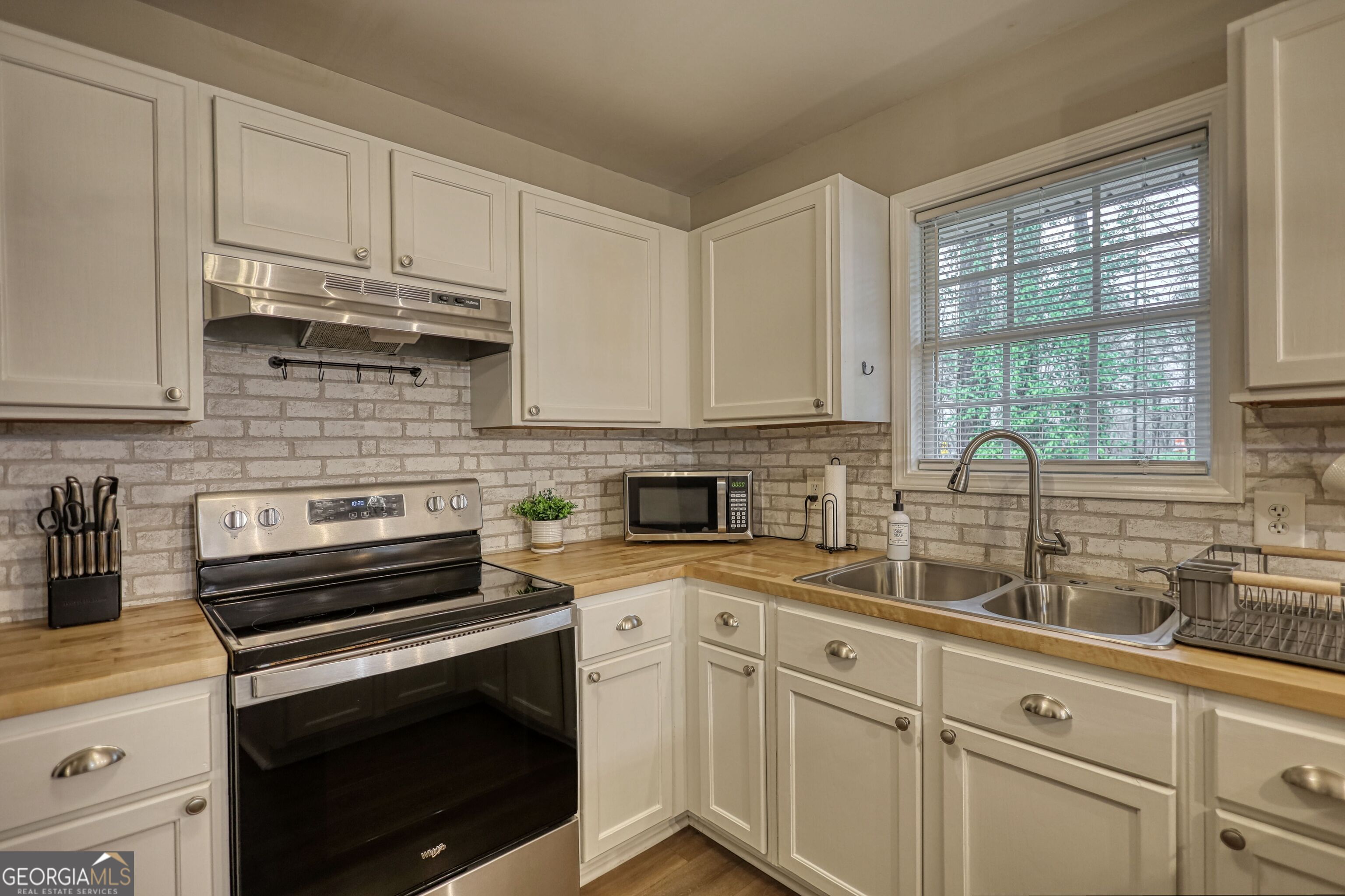 30 Waters Street Monticello, GA 31064 - Photo 12 of 40 a kitchen with appliances cabinets and a sink
