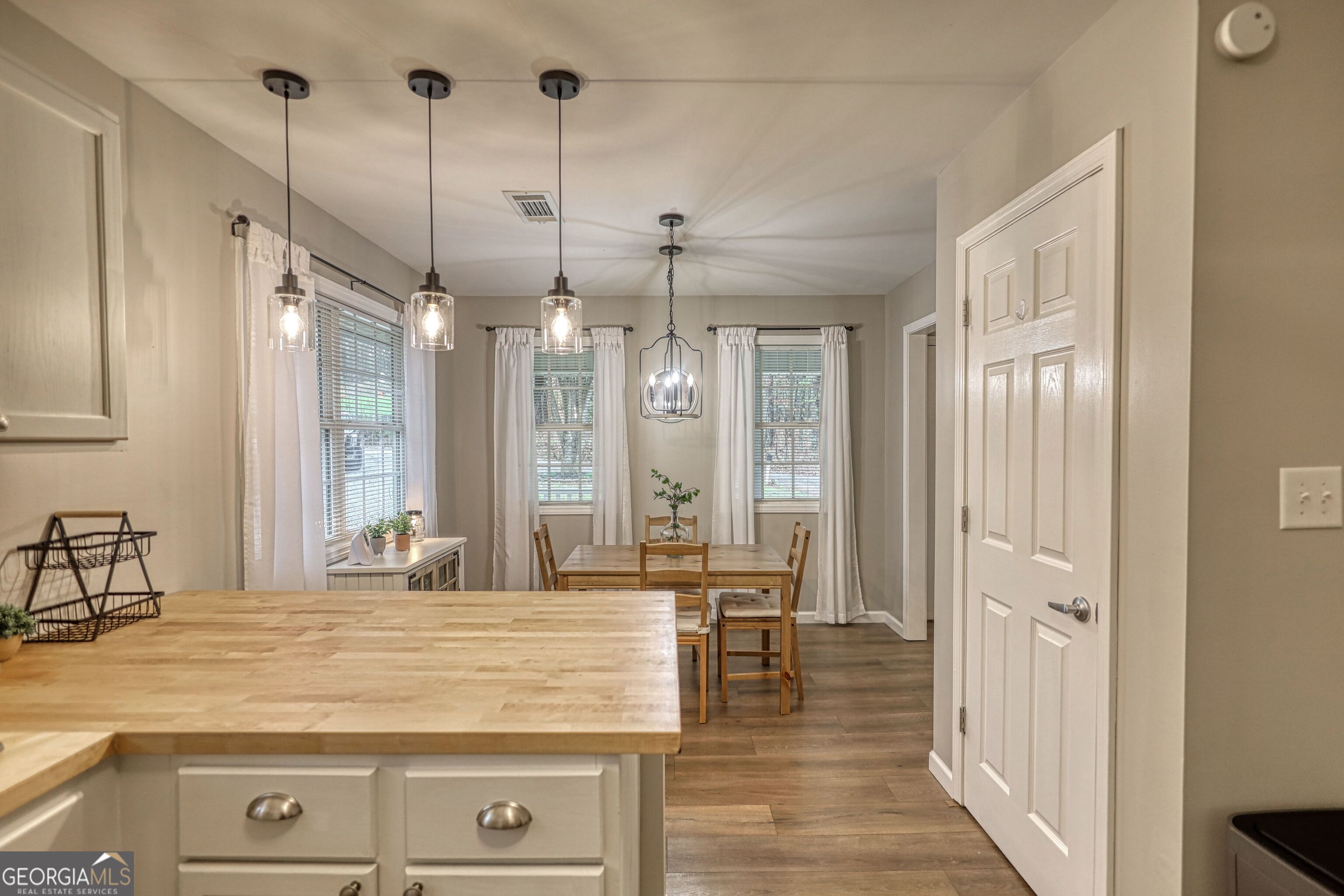 30 Waters Street Monticello, GA 31064 - Photo 13 of 40 a view of a kitchen with kitchen island a counter top space and a chandelier
