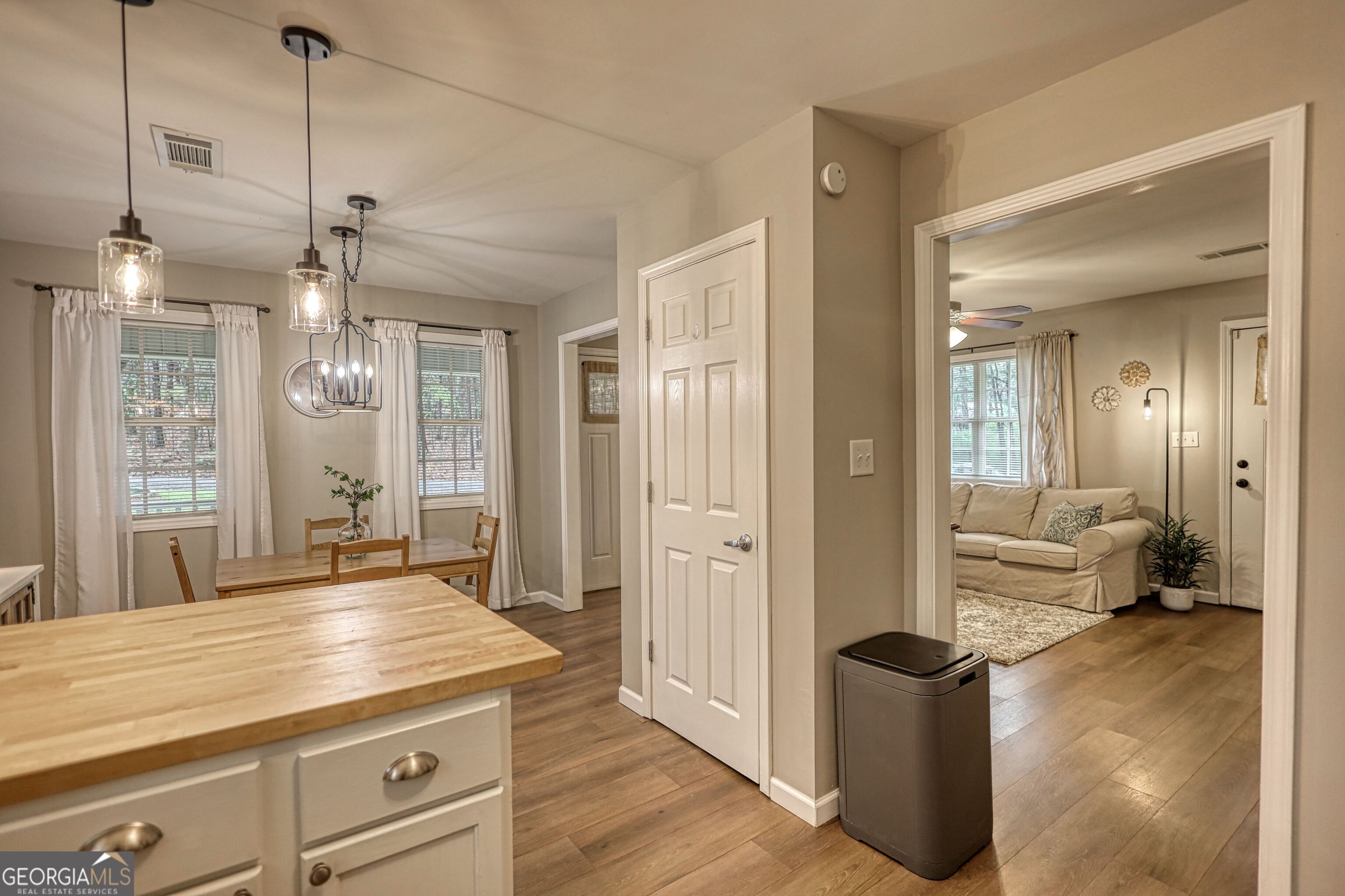 30 Waters Street Monticello, GA 31064 - Photo 14 of 40 a living room with kitchen island granite countertop furniture and a chandelier