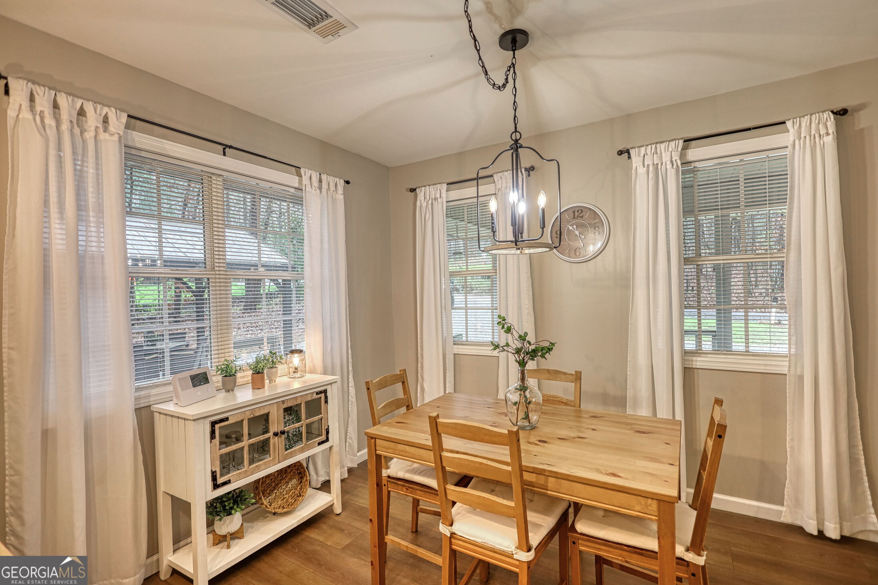 30 Waters Street Monticello, GA 31064 - Photo 15 of 40 a view of a dining room with furniture large windows and wooden floor