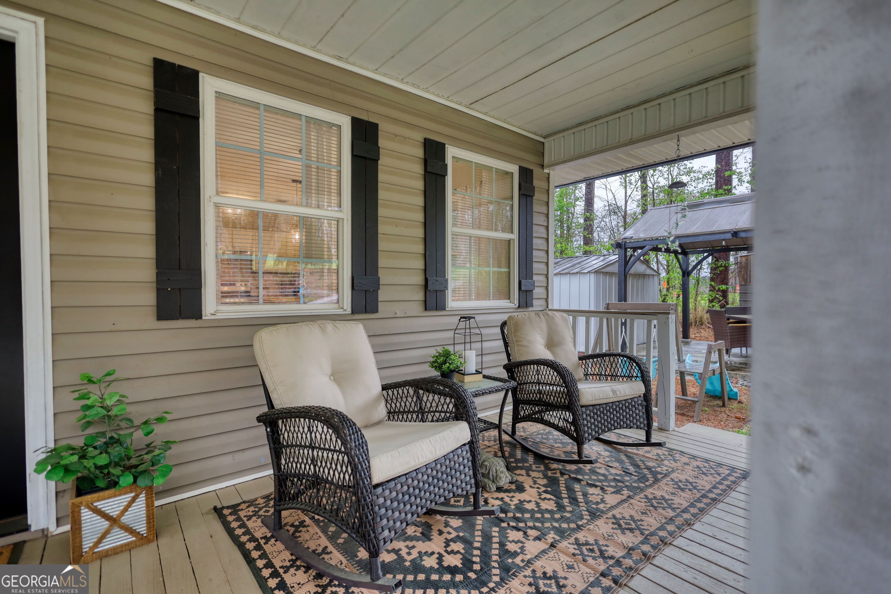 30 Waters Street Monticello, GA 31064 - Photo 32 of 40 a outdoor living space with furniture and a potted plant