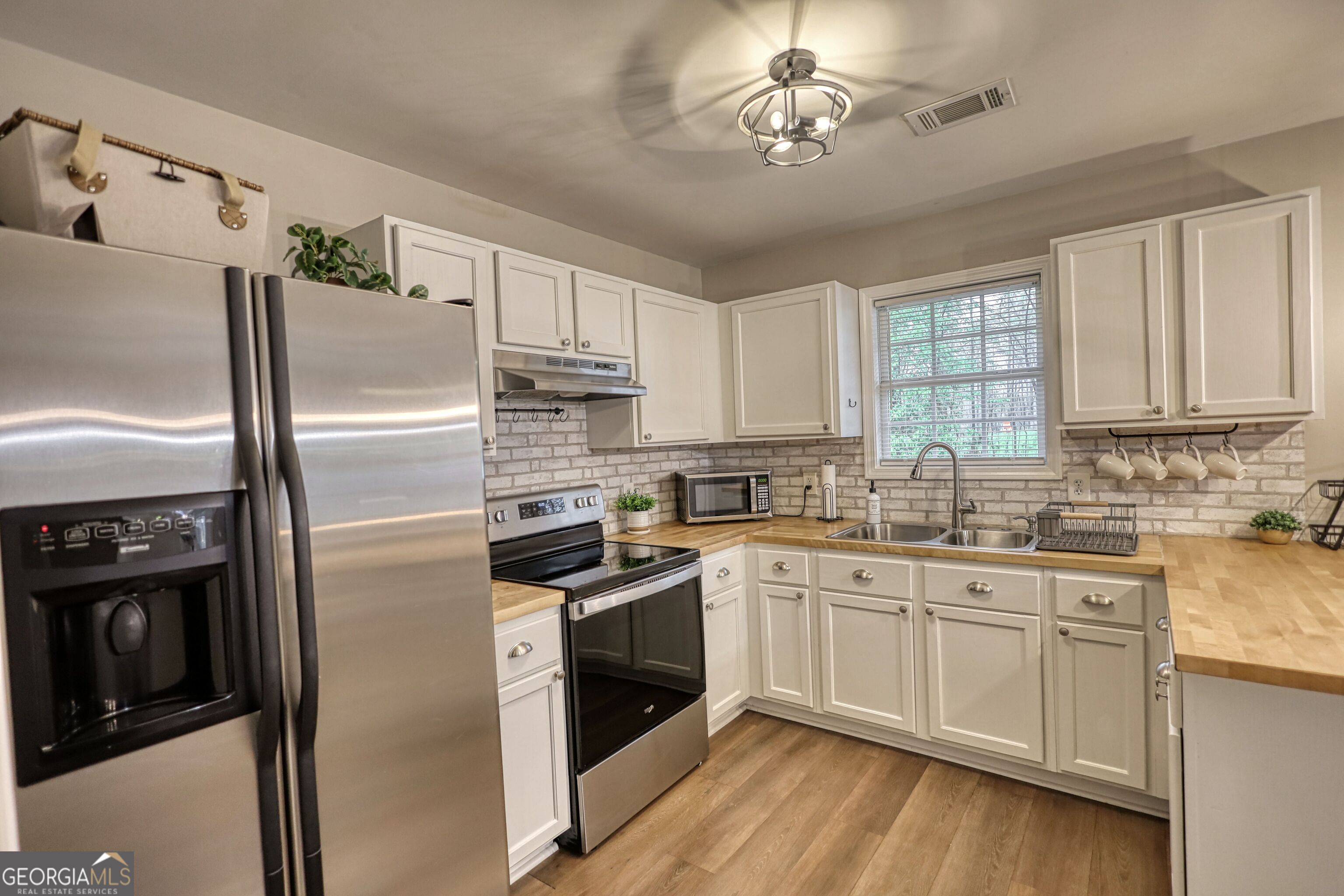 30 Waters Street Monticello, GA 31064 - Photo 8 of 40 a kitchen with stainless steel appliances a refrigerator sink and cabinets