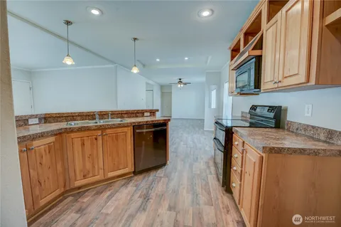 a kitchen with stainless steel appliances granite countertop a stove and a sink
