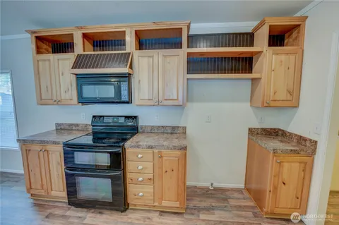 a kitchen with stainless steel appliances granite countertop a stove and a microwave