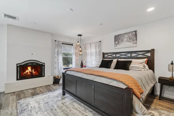 a bedroom with a bed and a fireplace