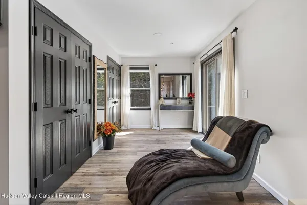 a bedroom with furniture and a book shelf