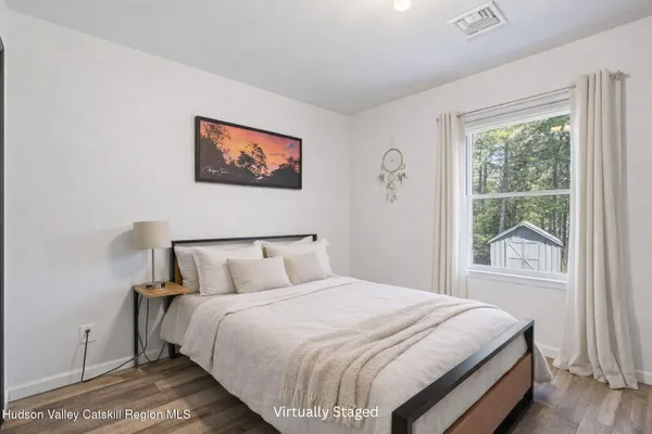 a bedroom with a bed and a window