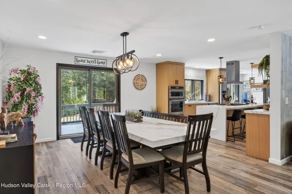 a view of a dining room with furniture window and wooden floor