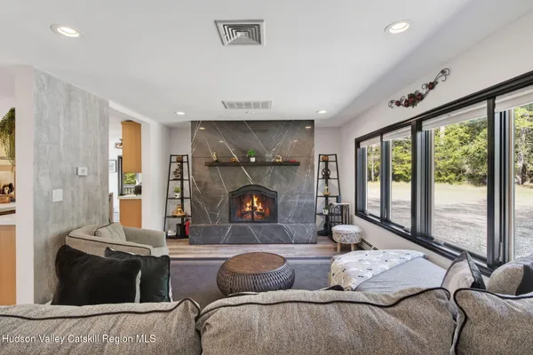 a living room with furniture and a fireplace
