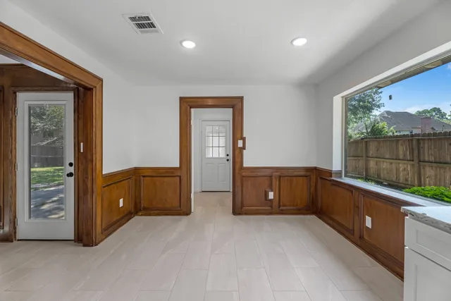 a room with a bed and a dresser