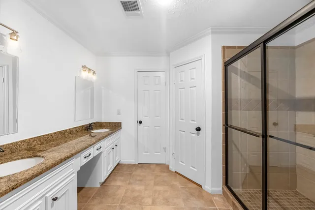 a kitchen with granite countertop a sink and a refrigerator