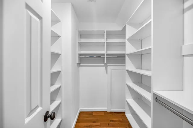 a view of walk in closet with empty racks