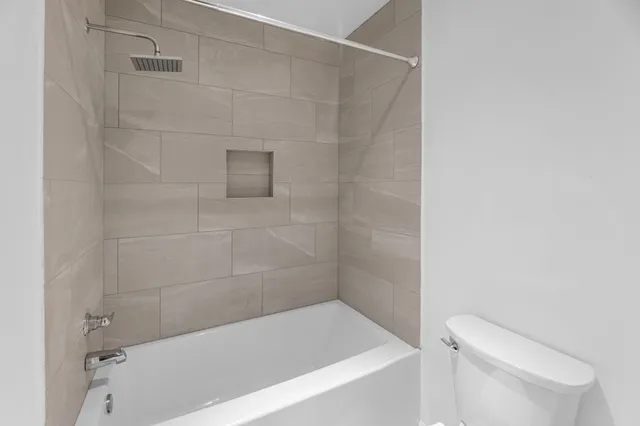 a bathroom with a bathtub and toilet