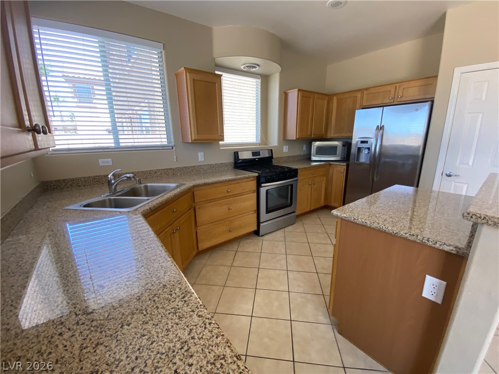 489 Foster Springs Road Las Vegas, NV 89148 - Photo 4 of 30 Culinary delights await in this well-appointed kitchen, showcasing ample counter space and modern appliances.