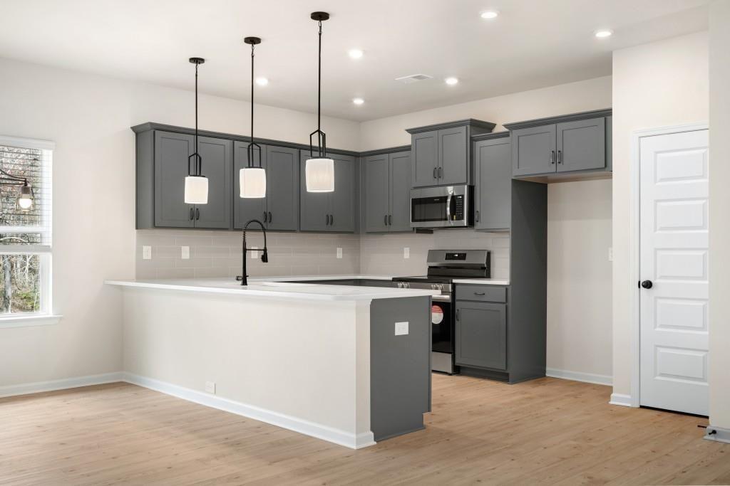 154 Red Oak Lane Calhoun, GA 30701 - Photo 14 of 36 a kitchen with stainless steel appliances granite countertop a sink a stove and a refrigerator