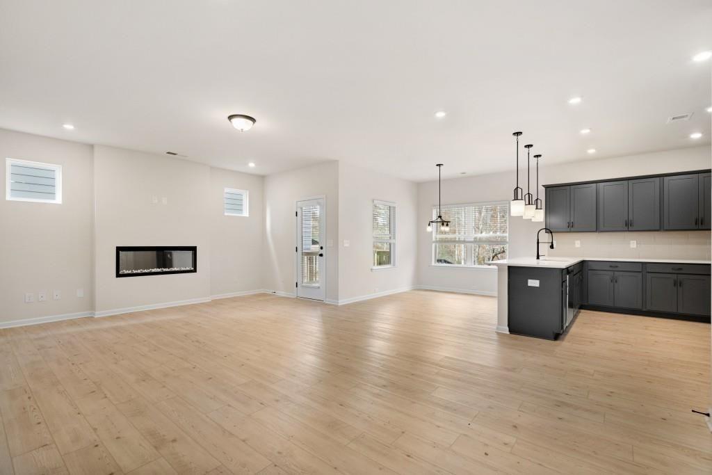 154 Red Oak Lane Calhoun, GA 30701 - Photo 9 of 36 a large kitchen with a large counter top a sink stainless steel appliances and cabinets