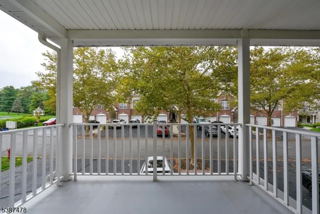 a view of a deck with a water fountain and a floor to ceiling window